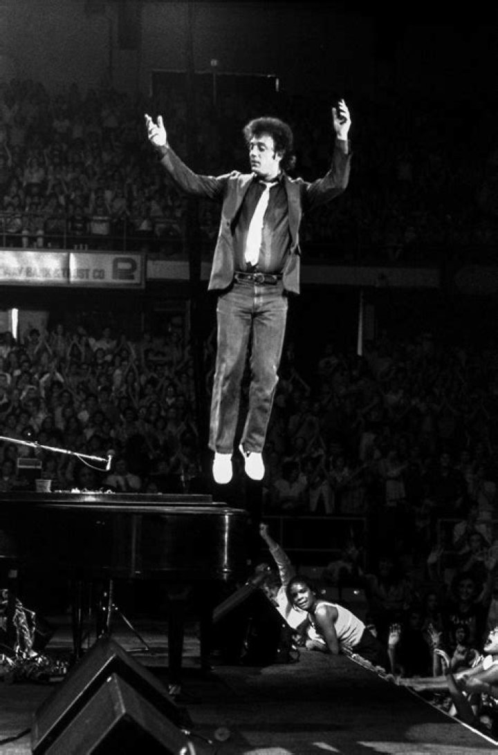 A young Billy Joel performing on stage in the 1970s