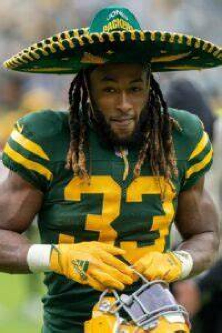 Aaron Jones as seen while carrying the ball for the Green Bay Packers during a game against the Washington Commanders on December 8, 2019