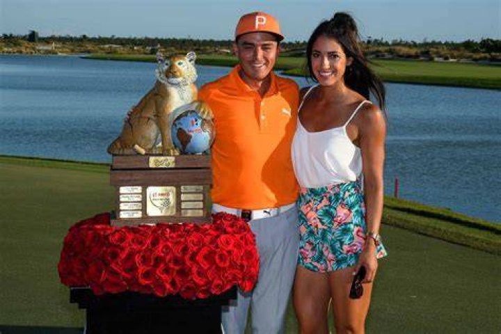 Allison Stokke and Rickie Fowler with the trophy at Hero World Challenge in December 2017