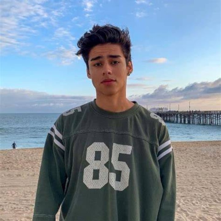 Andrew Davila as seen wearing a white shirt and posing for the camera alongside his friend, Brent Rivera, in February 2019
