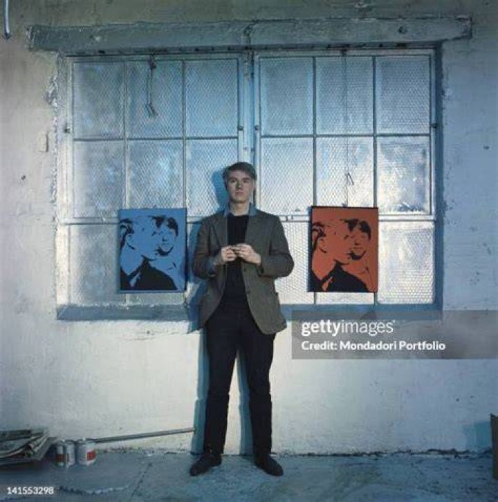 Andy Warhol posing with his pet dog Archie in 1973