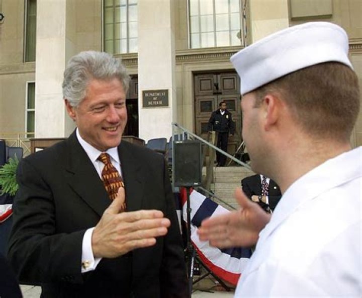 Bill Clinton while shaking hand with U.S. service members in 1999