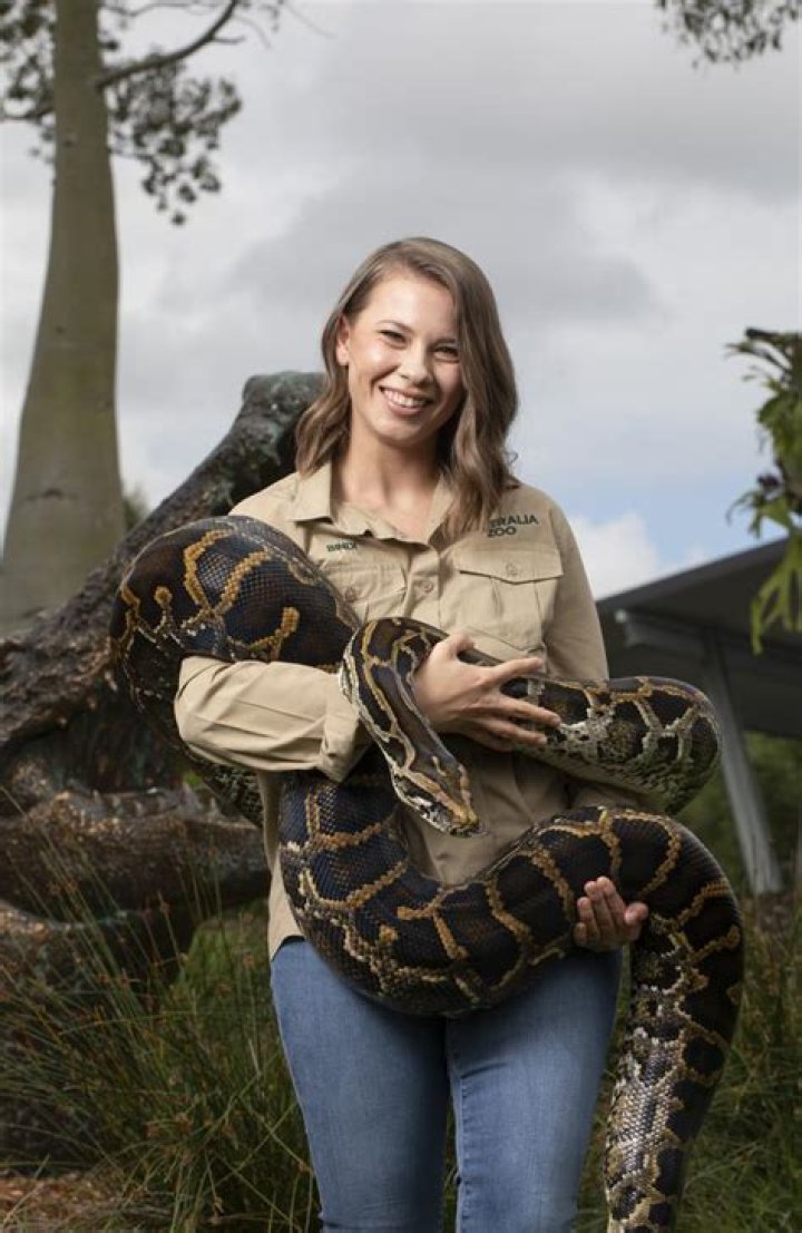 Bindi Irwin holding a snake in 2015