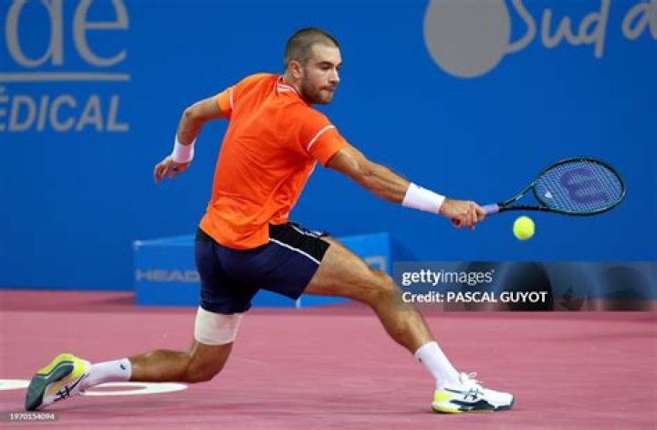 Borna Coric returns the ball against Bernard Tomic at 2016 French Open on May 26, 2016 in Paris