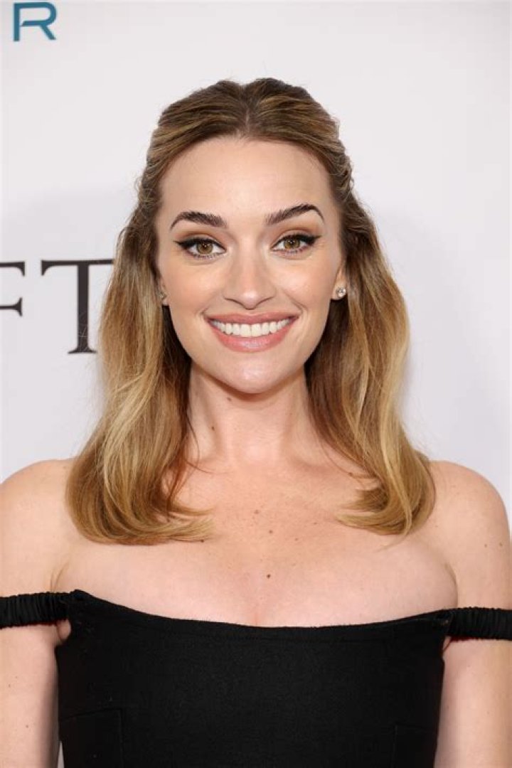Brianne Howey smiling for a picture with her dog in May 2020