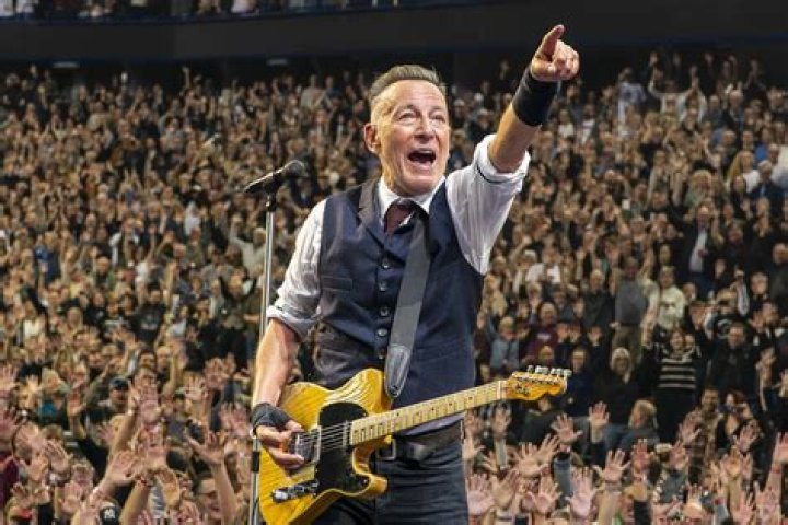 Bruce Springsteen performing at a concert with Max Weinberg in the back in August 2008