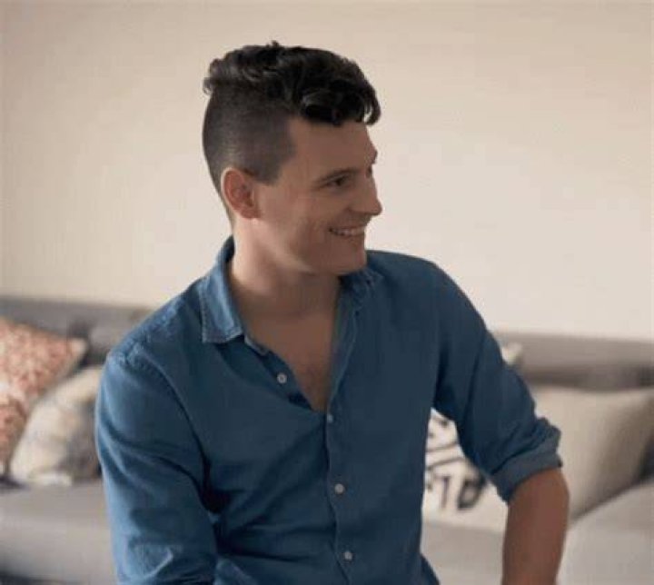 Bryan Dechart smiling for a picture while on a rowboat in Paris, France along with his beloved lady, Amelia Rose Blaire, in May 2017