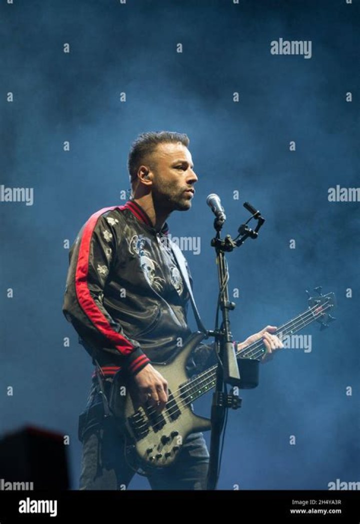 Chris Wolstenholme performing on stage with his band Muse in October 2007