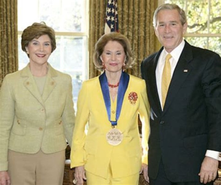 Cyd Charisse (Center) pictured with George W. and Laura Bush while accepting the National Medal of Arts and Humanities Award in an Oval Office ceremony on November 9, 2006