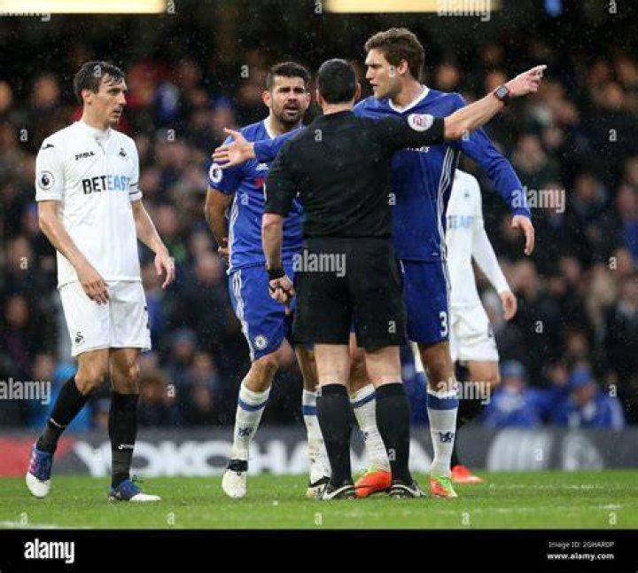 Diego Costa appeals to the referee after being fouled by the defender