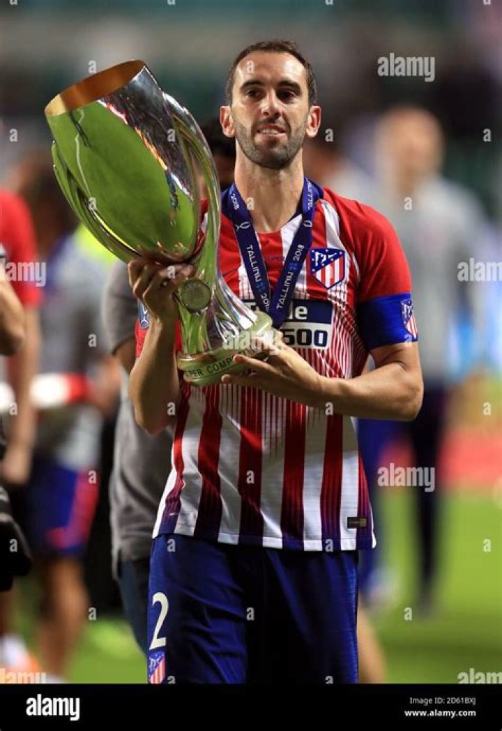 Diego Godin celebrates after winning La Liga Cup trophy after a match against SD Eibar on August 30, 2014