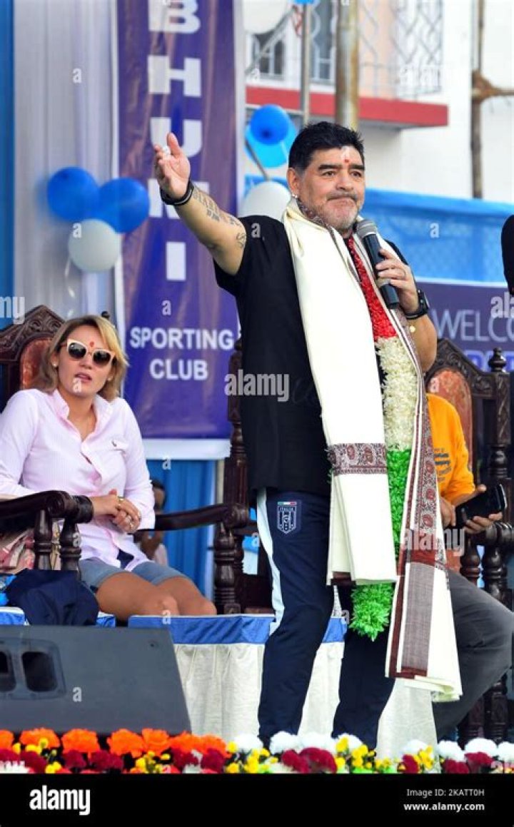 Diego Maradona with girlfriend Rocio Oliva at Buenos Aires airport in 2012