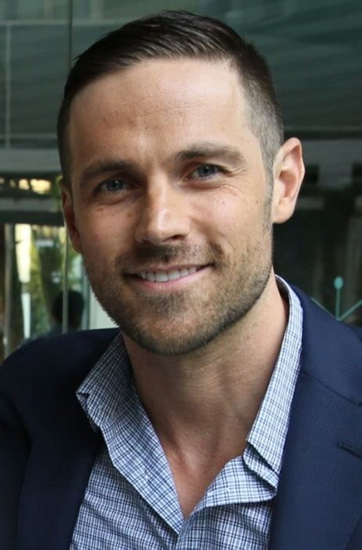 Dylan Bruce (Left) as seen while posing for the camera alongside John Fawcett at the CFC event in Los Angeles, California in May 2015