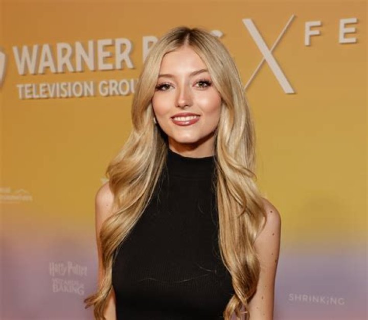 Emily Dobson smiling in a picture alongside Maluma at The Forum in Inglewood, California in September 2019