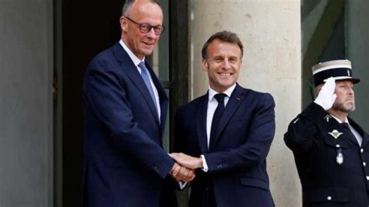 Emmanuel Macron shaking hands with German Chancellor Angela Merkel in October 2017