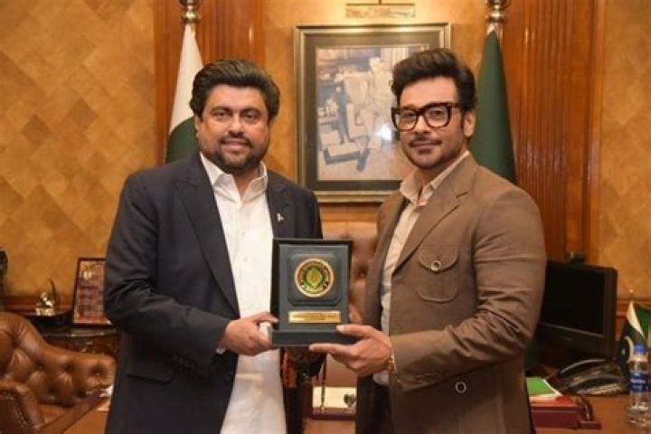 Faysal Quraishi seen receiving an award from Governor Kamran Tessori in December 2023