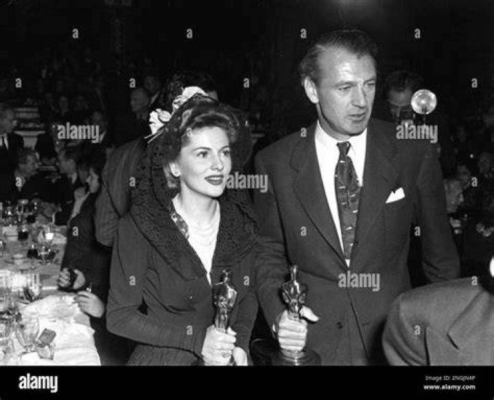 Gary Cooper and Joan Fontaine pictured while holding their Oscars at the Academy Awards after party, 1942