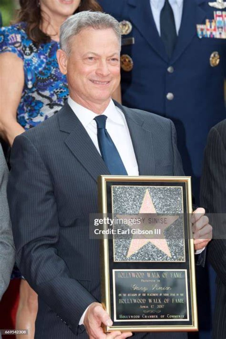 Gary Sinise being honored as an honorary chief petty officer by Fleet Master Chief Michael Stevens during a ceremony at the Navy Memorial and Naval Heritage Center in August 2012