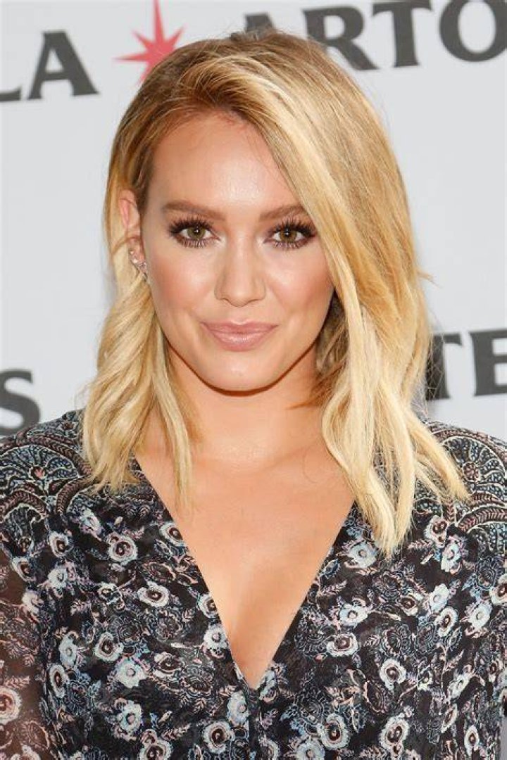 Hilary Duff with Stella Artois bottles during a Summer Party in June 2016