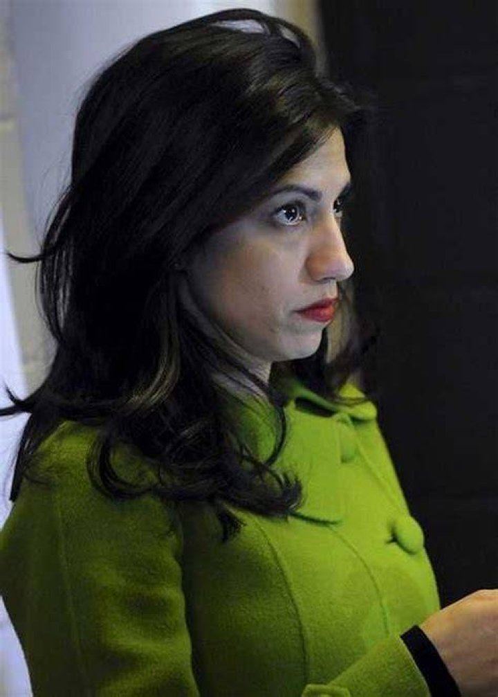 Huma Abedin while checking messages on her phone