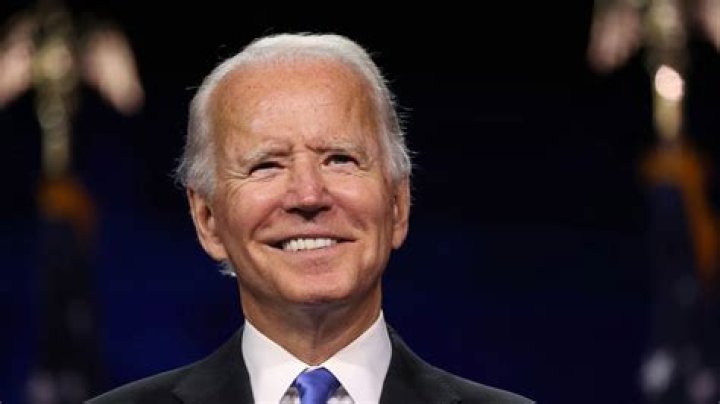 Joe Biden as seen while smiling in a picture taken in his West Wing Office at the White House in January 2013