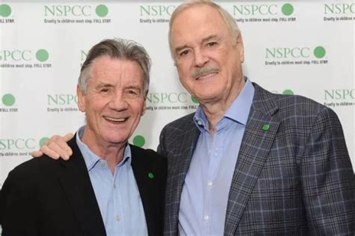 John Cleese and Michael Palin (Standing) during the 'Argument Clinic' sketch at 'Monty Python Live (Mostly)' in 2014