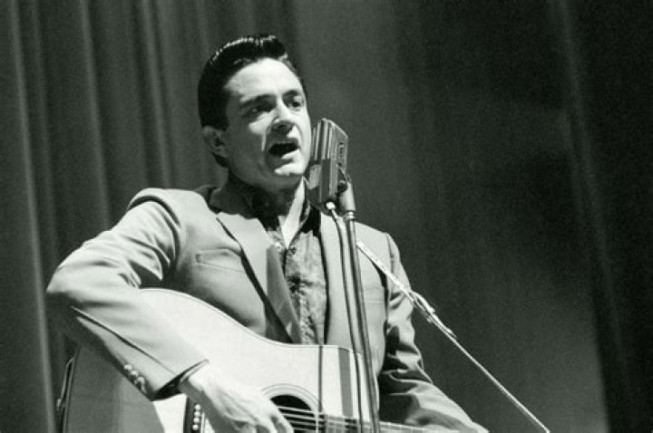 Johnny Cash (Left) singing with a Navy lieutenant during a military event c. January 1987