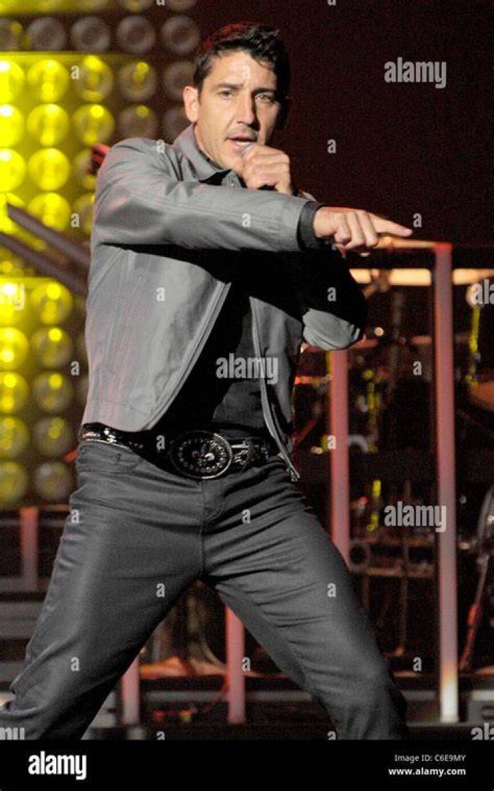 Jonathan Knight performing on stage in 2011