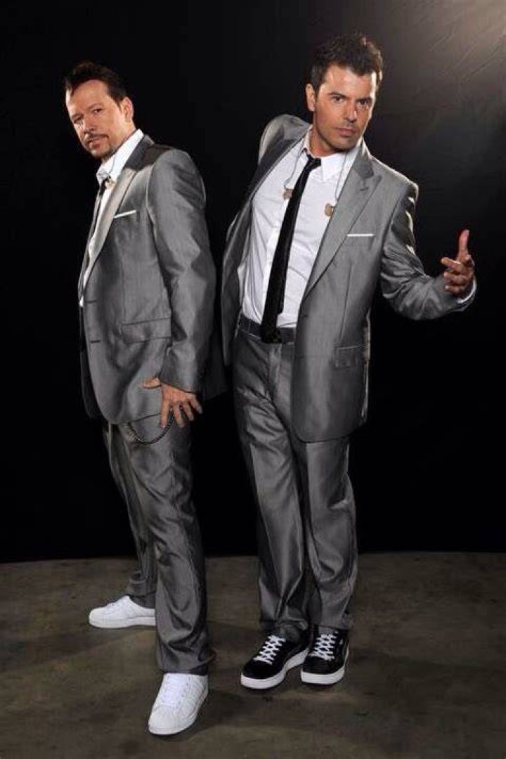 Jordan Knight and Donnie Wahlberg posing backstage at the 1990 Grammy Awards