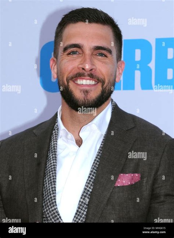 Josh Segarra smiling for a picture alongside his sons in June 2020