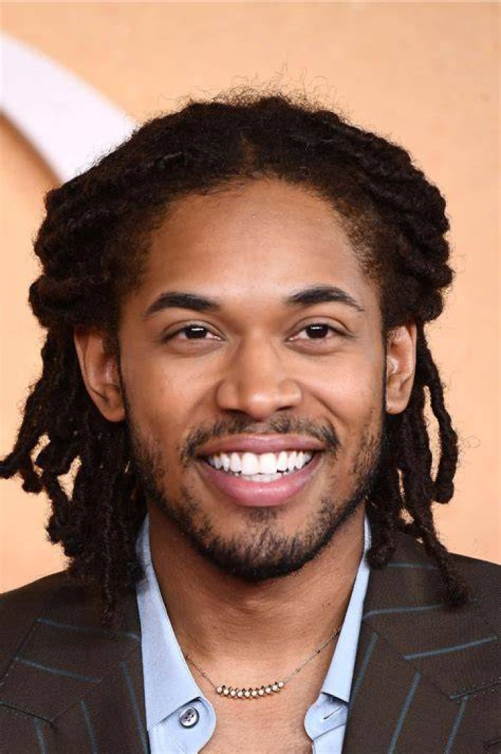 Kelvin Harrison Jr. smiling in a picture with Taylor Russell