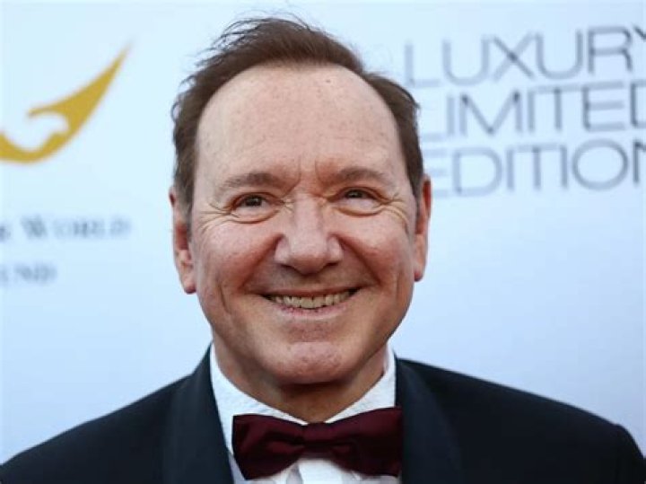 Kevin Spacey posing with a Elvis Presley statue in April 2016