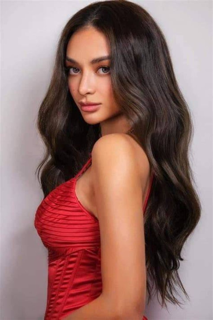 Kylie Verzosa posing for the camera in a white dress
