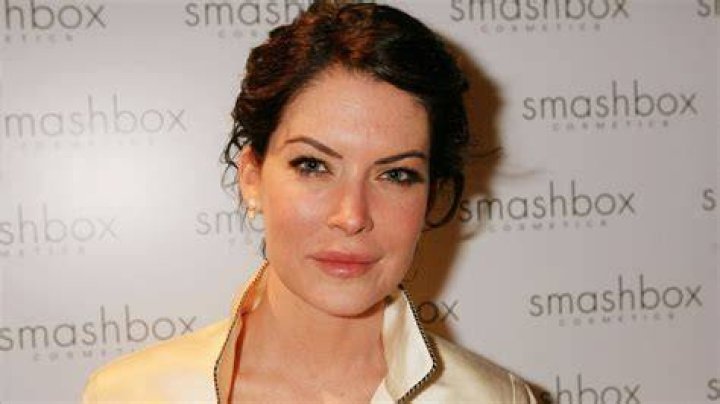Lara Flynn Boyle as seen while smiling for the camera along with Kyle MacLachlan at the 42nd Emmy Awards - Governor's Ball in September 1990