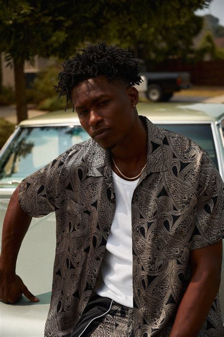 Lucky Daye smiling for the camera in November 2019
