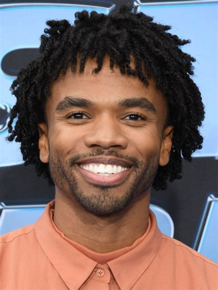 Luke Youngblood smiling in a picture alongside Oprah Winfrey in Los Angeles, California, United States