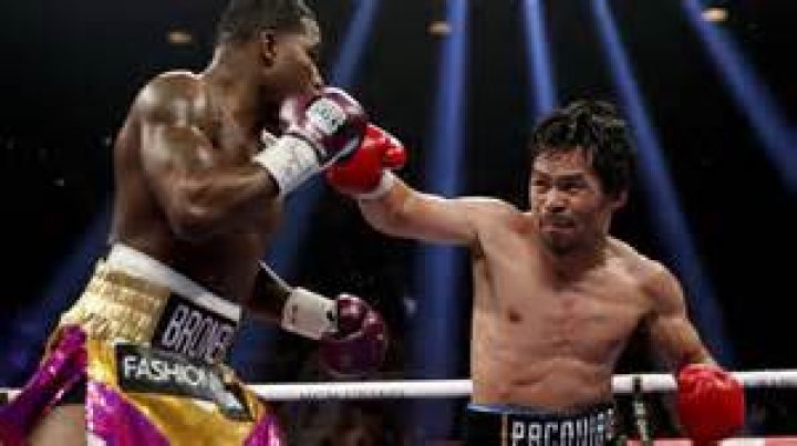 Manny Pacquiao throws his short right hook at Floyd Mayweather Jr. during their welterweight unification championship bout on May 2, 2015 at MGM Grand Garden Arena in Las Vegas, Nevada