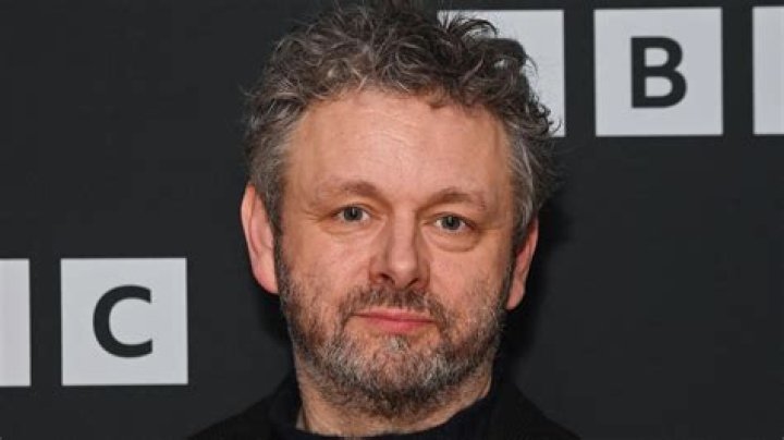 Michael Sheen posing with his BIFA Award
