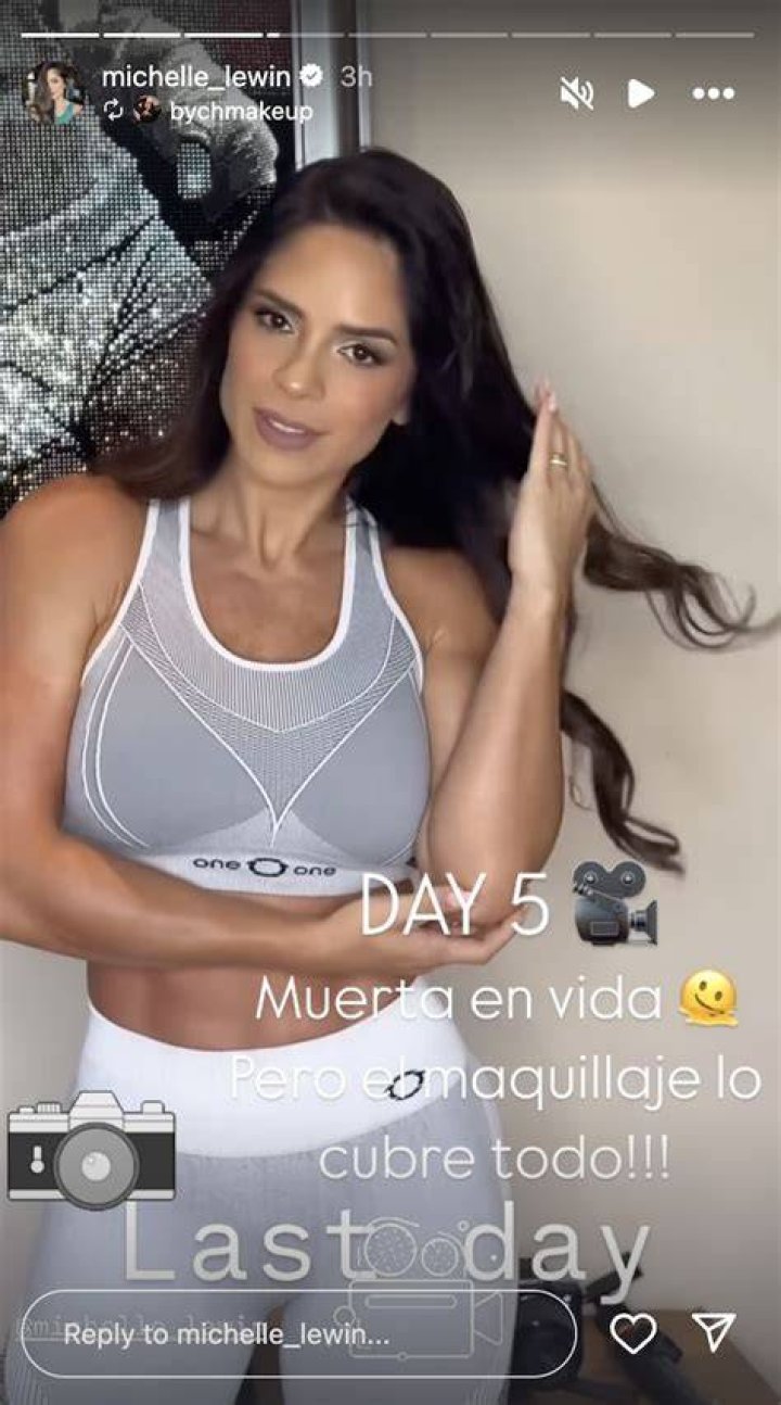Michelle Lewin showing her abs and arms.