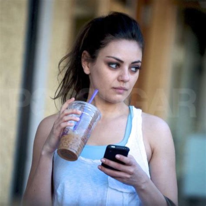 Mila Kunis drinking juice