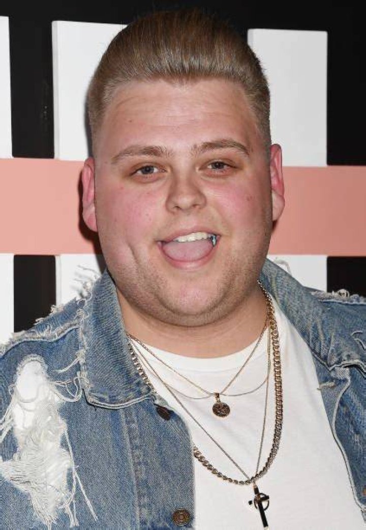 Nick Crompton sporting a white outfit while posing with his father in December 2017