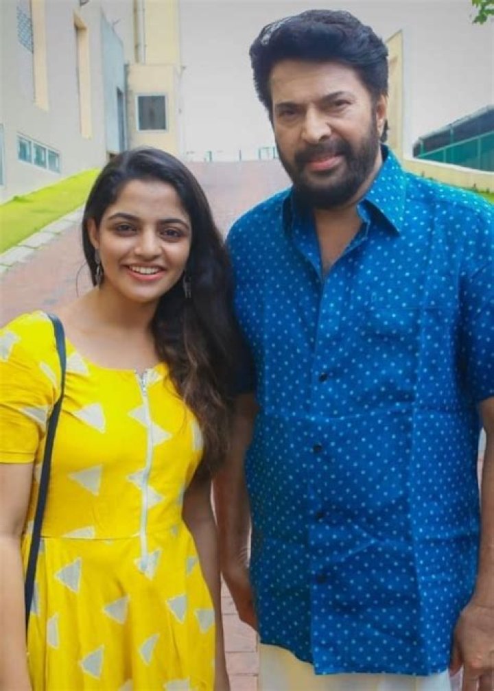 Nikhila Vimal smiling for a picture alongside Mammootty