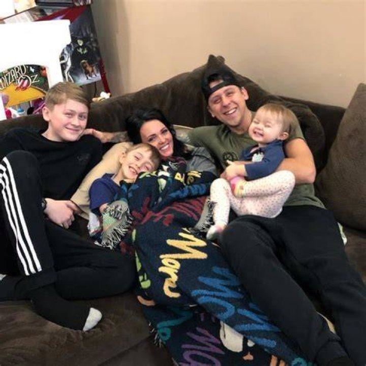 Noah Atwood (Corner Left) smiling in a picture alongside his family in March 2019