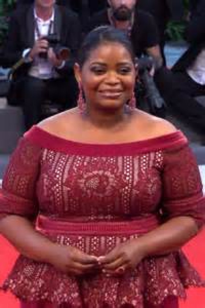Octavia Spencer in a red cocktail dress during Governor Awards in November 2013