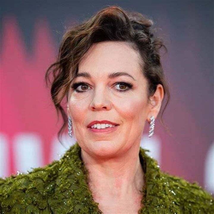 Olivia Colman posing with a trophy