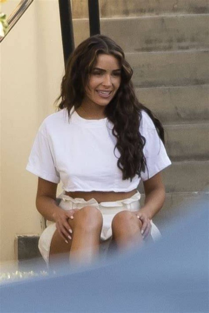 Olivia Culpo posing on a boat in June 2022