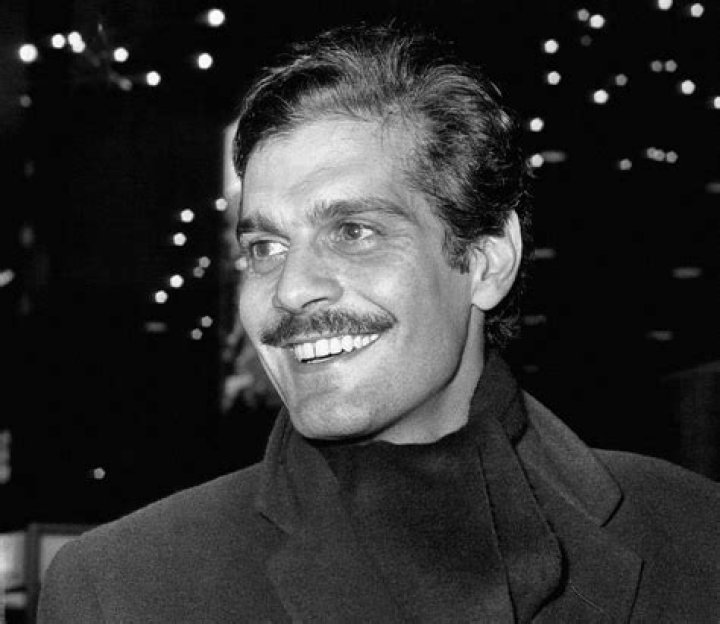 Omar Sharif as seen while smiling in a black-and-white picture in 1963