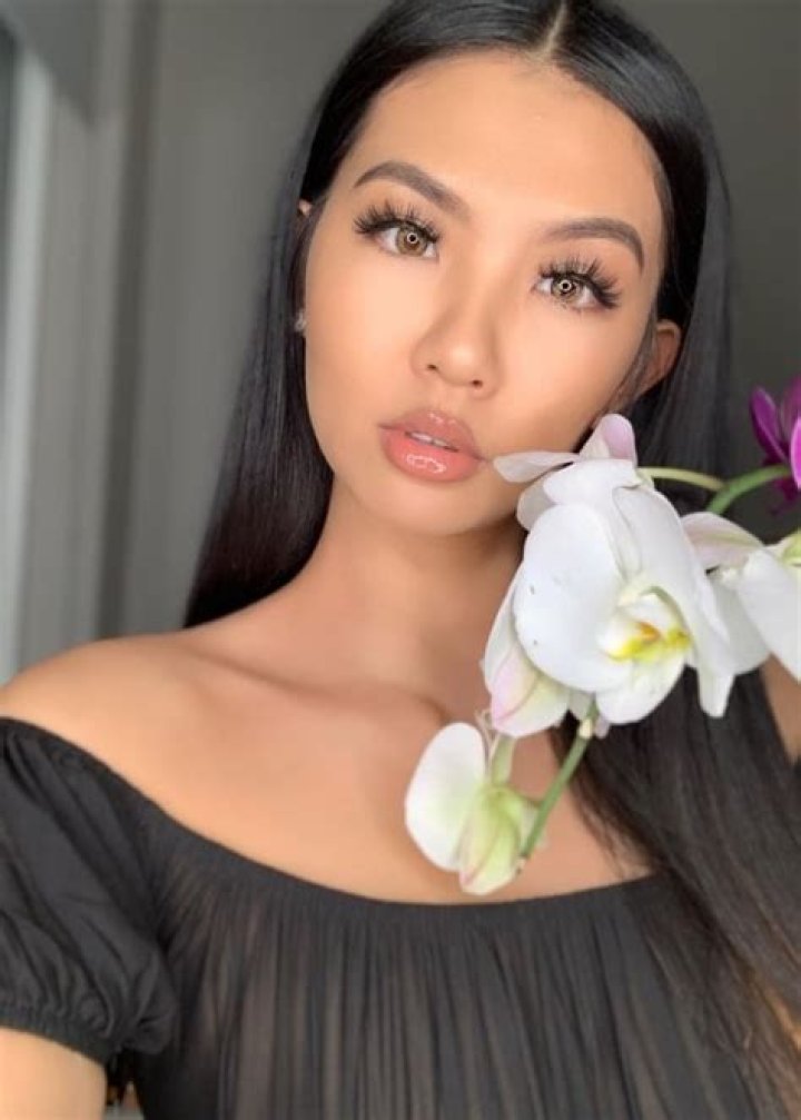 Phi Tran as seen in a white outfit while posing for a goofy picture along with Jaclyne Nguyen in September 2018 in Los Angeles, California, United States