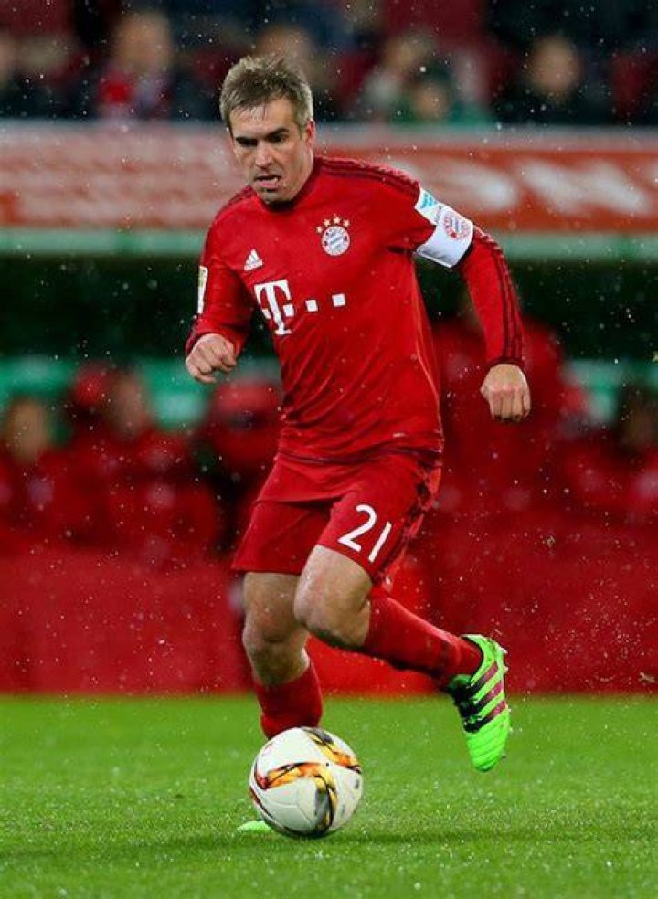 Philipp Lahm handles the ball during a match between Bayern Munich and FC Augsburg on February 14, 2016 in Augsburg, Germany
