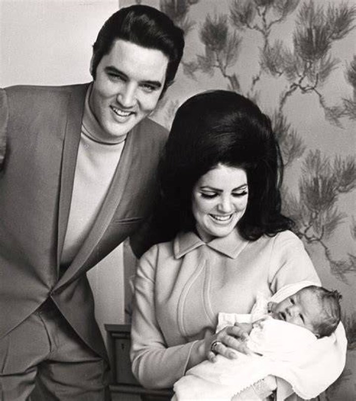 Priscilla Presley and Elvis Presley as seen with newborn Lisa Marie in a black-and-white picture in February 1968